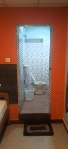 a bathroom with a toilet and a shower in a room at R R Homes in Kumbakonam