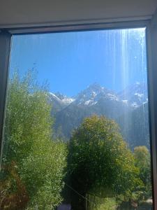 a window with a view of a mountain at Pranshi Home Stay Kalpa in Chini