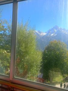 a window with a view of a mountain at Pranshi Home Stay Kalpa in Chini