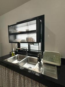 a kitchen sink with a window above it at D sleep Villa Chiangmai in Chiang Mai