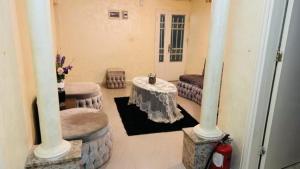 a living room with a table and columns in a room at Petra center suite in Wadi Musa