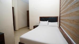 Ένα ή περισσότερα κρεβάτια σε δωμάτιο στο Olive Green Hotel