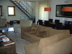 a living room with a couch and a dining room at Moinho da Ponte Velha in Bragança