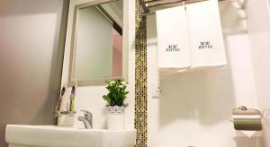 a bathroom with a sink and a mirror at Metro Winner Hotel in Hong Kong
