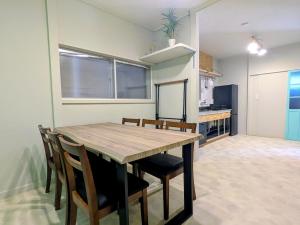 a kitchen and dining room with a table and chairs at サマサマアイル saMa-saMa Aisle in Odawara +4 photos