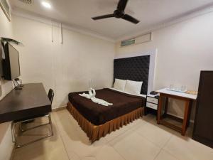 a bedroom with a bed with a white animal on it at Hotel Al Sana in Kolkata