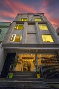 a tall building with stairs in front of it at Tripli Hotels Sandalwood in Varanasi