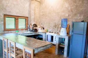 a kitchen with a blue refrigerator and a table at Sea Esta Cruz Siargao in General Luna +17 photos