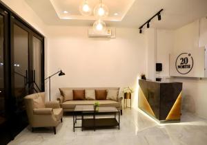 a living room with a couch and a table at 20 North Hotel Mae Sai in Mae Sai