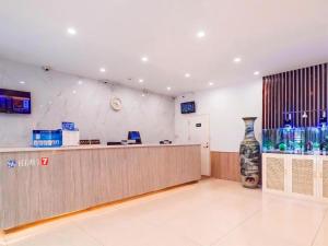 a waiting room with a counter in a store at 7 Days Premium·Tianjin Gulou Metro Station Joy City in Tianjin