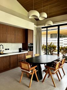 a kitchen with a table and chairs in a room at Siam Residence - Modern Villa with a Private Pool in Koh Phangan +21 photos