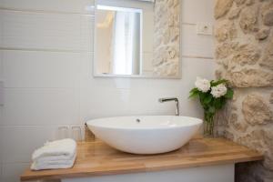 a bathroom with a white sink and a mirror at Barone Room in Šibenik