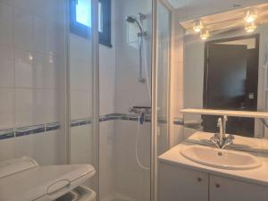 a white bathroom with a shower and a sink at Appartement 2 pièces CAP D'AGDE CT865-2113 in Cap d'Agde +9 photos