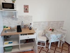 a kitchen with a sink and a table and chairs at Alloggio San Francesco in Peschiera del Garda