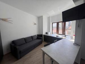 a living room with a couch and a table at AT Modern Boutique in Bucharest