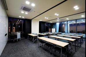a dining room with tables and chairs and windows at Kintex by K-tree in Goyang