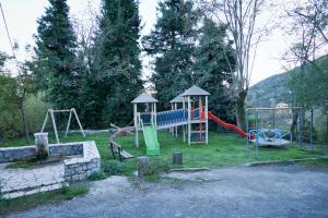 a park with a playground with a slide at Elova in Zátouna
