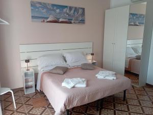 a bedroom with a bed with two towels on it at Alloggio San Francesco in Peschiera del Garda