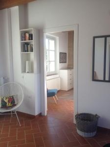 a living room with a chair and a mirror at La Famulenta garden apartment in Grazzano Badoglio