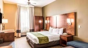 a hotel room with a large bed and a couch at Hawthorn Extended Stay by Wyndham Amarillo in Soncy +49 photos