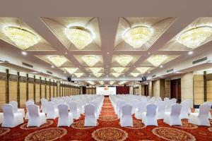 a room with rows of white chairs and a stage at New Century Hotel Nanjing in Nanjing +255 photos