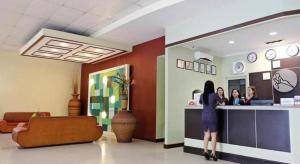 a woman standing at a counter in a waiting room at Holiday Spa Hotel in Mabolo +175 photos