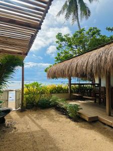 a hut with a deck with a view of the ocean at Panari Lodge El Nido in El Nido