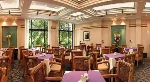 a restaurant with purple tables and chairs and windows at Chengde Yunshan Hotel in Chengde