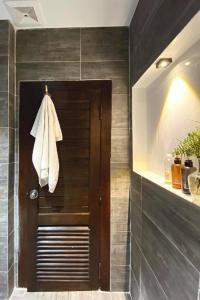 a bathroom with a towel hanging on a door at Reasmey Cheanich Hotel in Kampong Cham +66 photos