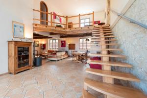 a room with a staircase and a living room at Maison avec piscine in Marciac