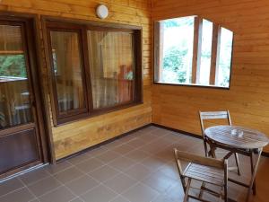 a room with a table and chairs in a cabin at Green Eden Lepsa in Lepşa