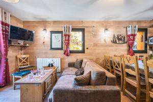 a living room with a couch and a table at Chalet Refuge Loup Blanc Valfréjus in Valfréjus