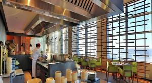 a chef preparing food in a large kitchen at AOLUGUYA in Harbin