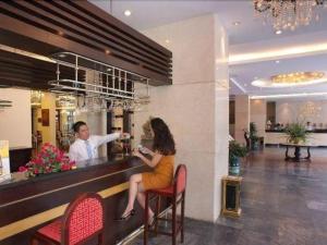 a man and a woman sitting at a bar at Huu Nghi Hotel in Hai Phong +107 photos