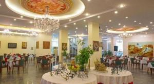 a banquet hall with tables and chairs and chandeliers at Huu Nghi Hotel in Hai Phong