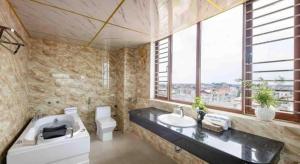 a bathroom with a tub and a sink and a toilet at Viet Village Hotel in Hanoi +214 photos