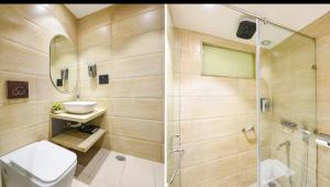 a bathroom with a shower and a toilet and a sink at Siya Residency in New Delhi