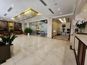 a lobby of a hotel with a large room at Lenid Hotel Tho Nhuom in Hanoi