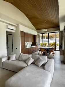 a living room with a couch and a table at Siam Residence - Modern Villa with a Private Pool in Koh Phangan