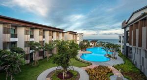 an apartment complex with a swimming pool in a courtyard at i Tara Private in Phetchaburi +55 photos