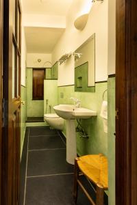 a bathroom with a sink and two toilets at The Colonial Courtyard in Kuilapayam