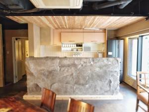 a kitchen with a large stone counter in a room at MATSUMOTO CASTLE hostel in Matsumoto