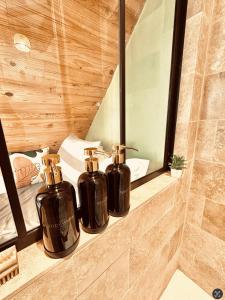 2 bouteilles sur une étagère dans une salle de bains dans l'établissement Atypical Studio - Allos, à Allos 13 autres photos