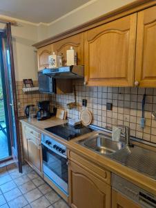 a kitchen with a sink and a stove at Ferienhaus Thomm in Konz