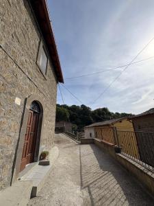 a stone building with a door on the side of it at Le coste sul lago in Montefiascone