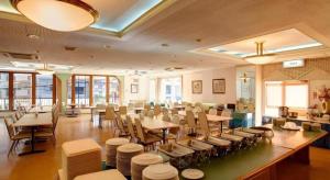 a restaurant with tables and chairs in a room at Okinawa Sunplaza Hotel in Naha