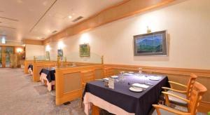 a dining room with two tables and a counter at Hotel Takeshima in Toyohashi +178 photos