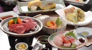a table topped with bowls of food on plates at Hotel Harvest In Yonago in Yonago +68 photos