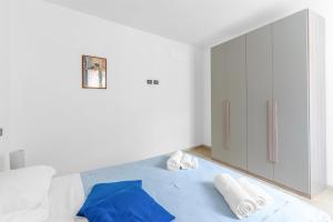 a bathroom with white walls and a large mirror at Casa della Regina, near Lake Garda in Montichiari