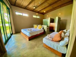 Postel nebo postele na pokoji v ubytování La Purita Ecolodge